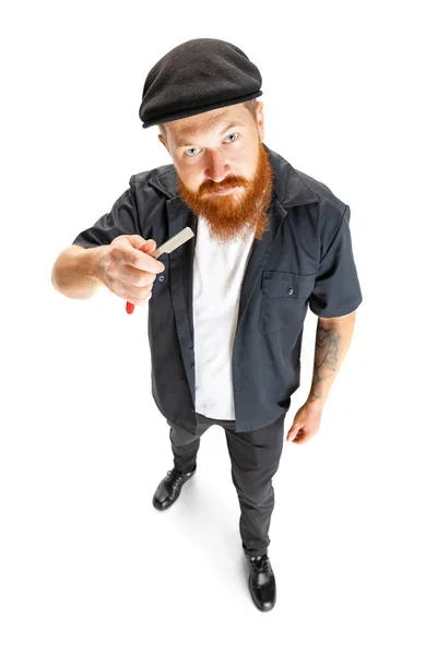 One stylish red-bearded man, barber or hair cutter isolated on white studio background. Holding cutting tools. — Stock Photo, Image