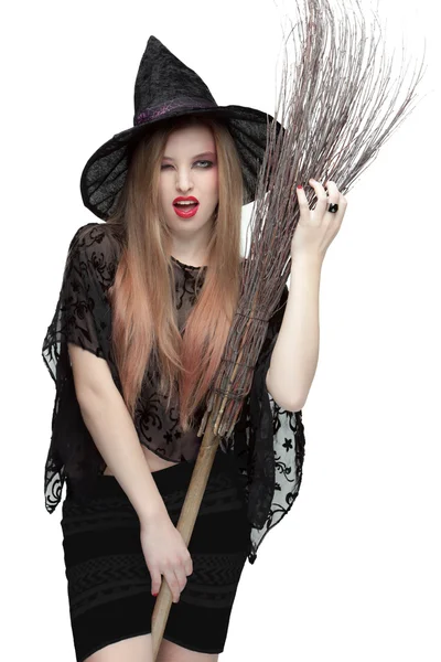 Woman winking eye in witch costume with a broom — Stock Photo, Image