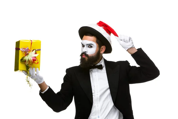 Man with christmas hat and a gift in their hands — Stock Photo, Image