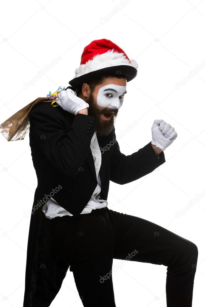 Man with christmas hat and a gift in their hands