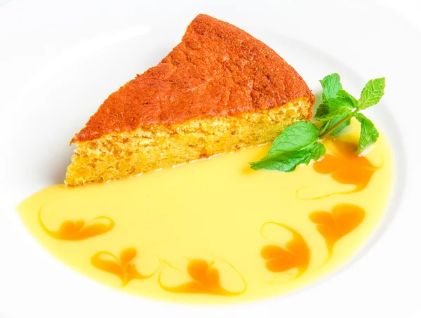 Piece of cake with yellow sauce — Stock Photo, Image
