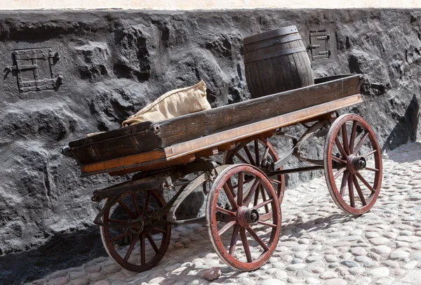 Old wooden cart on background of brick wall — Stock Image Old wooden cart on background of brick wall Royalty Free Stock Images