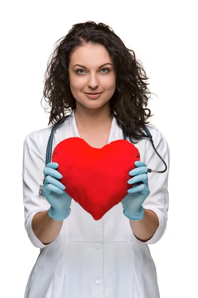 Pretty woman doctor holding a red heart — Stock Photo, Image