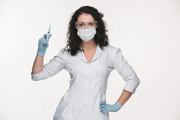 Portrait of lady surgeon showing syringe over white background — Stock Photo, Image