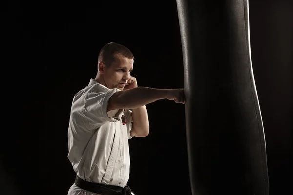 Karate kick in a punching bag — Stock Photo, Image