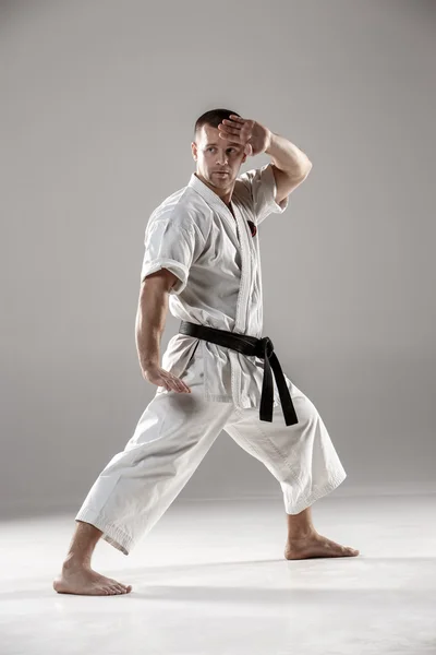 Man in white kimono training karate — Stok Foto
