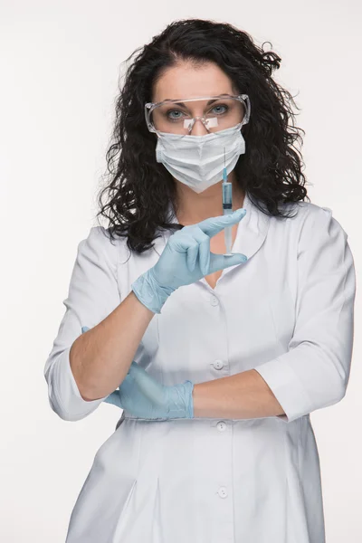 Portrait of lady surgeon showing syringe over white background — Stock Photo, Image