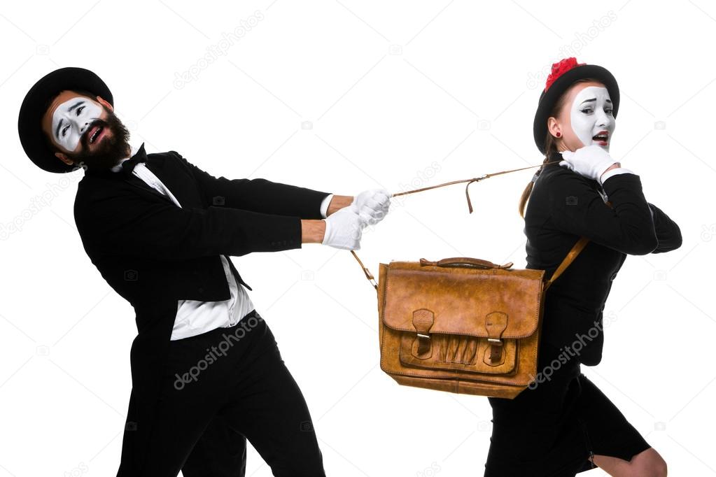 Business man and woman fighting over briefcase