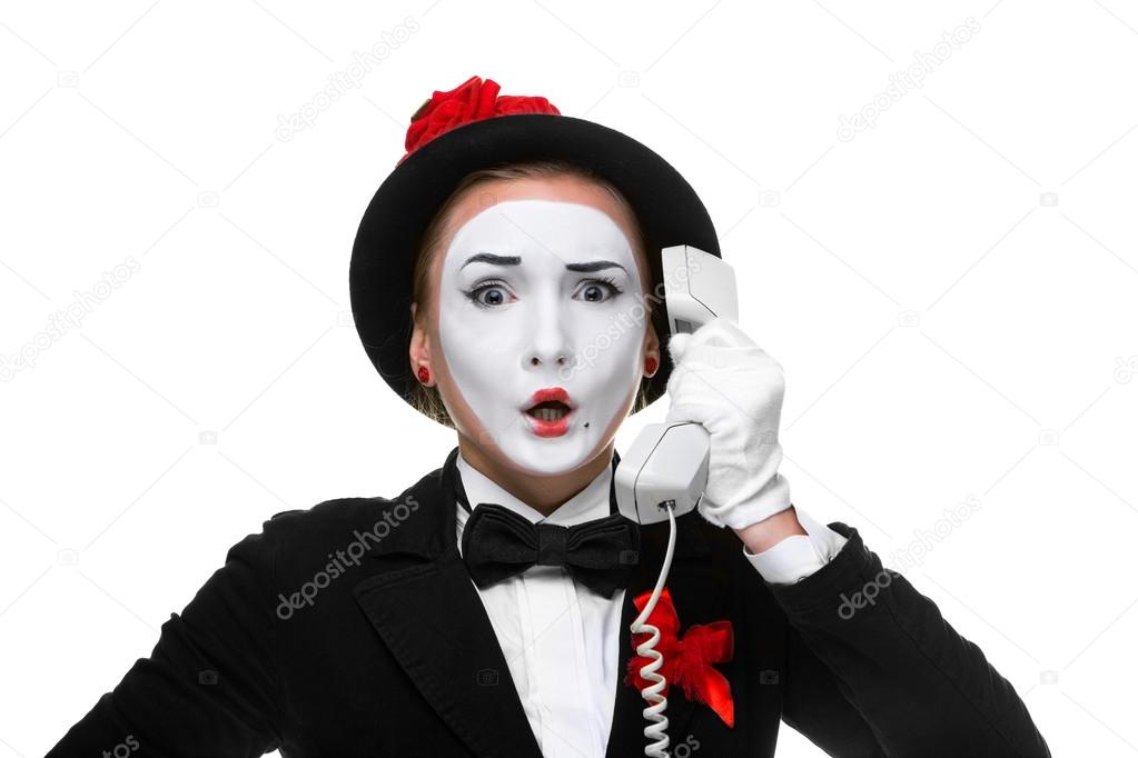 Woman in the image mime holding a handset.