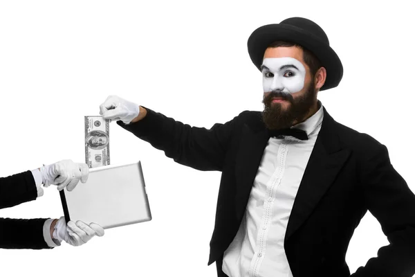 Businessmans hand in the form of mime extract money from tablet PC — Stock Photo, Image