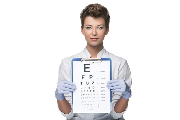 Young woman ophthalmologist with eye chart — Stock Photo, Image