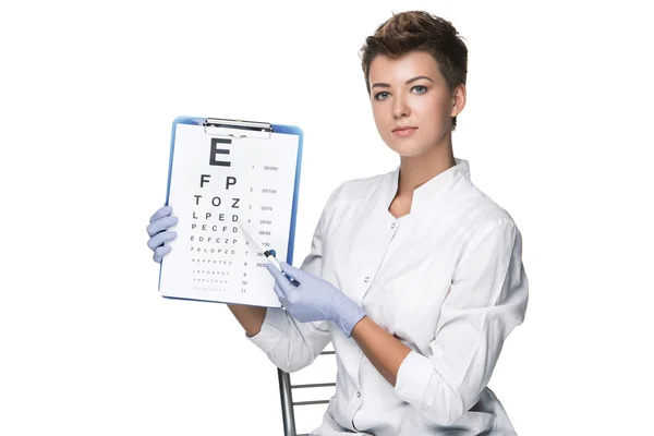 Young woman ophthalmologist with eye chart — Stock Photo, Image