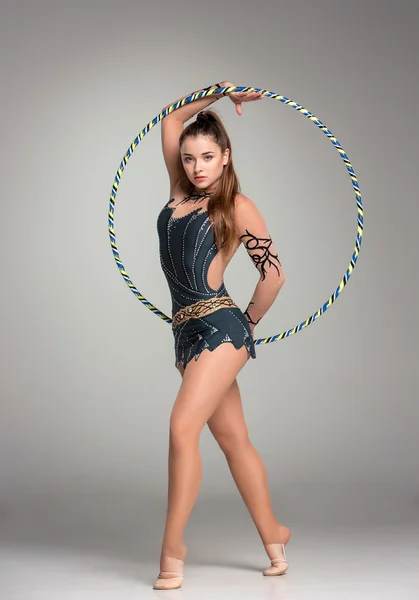 Tonåring gör gymnastik övningar med färgglada band — Stockfoto