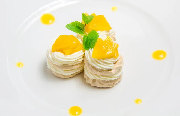 Three French meringue cookies on white plate — Stock Photo, Image