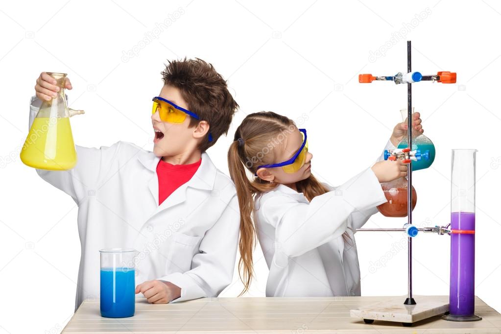 Two cute children at chemistry lesson making experiments