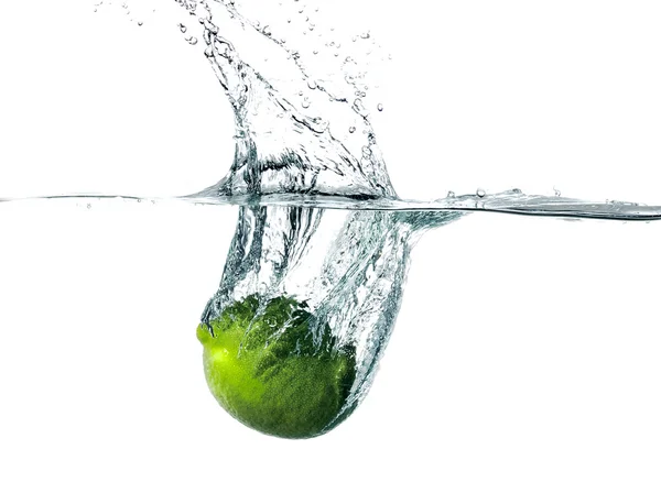 Fresh lime falling into water — Stock Photo, Image