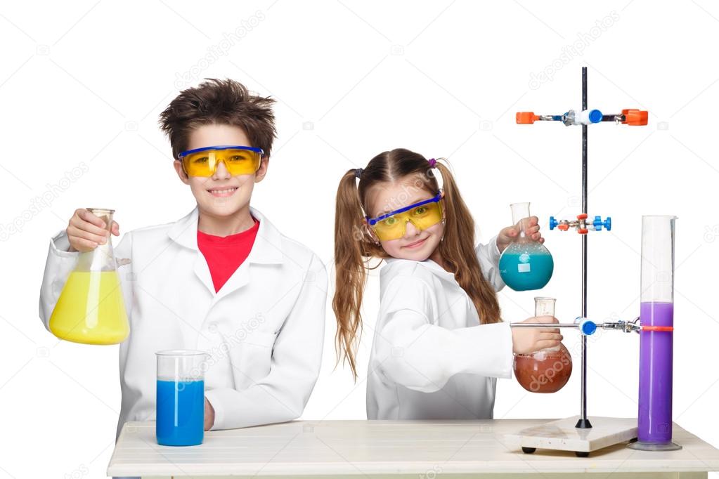 Two cute children at chemistry lesson making experiments