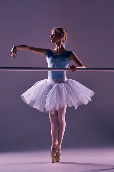 Classic ballerina posing at ballet barre — Stock Photo, Image