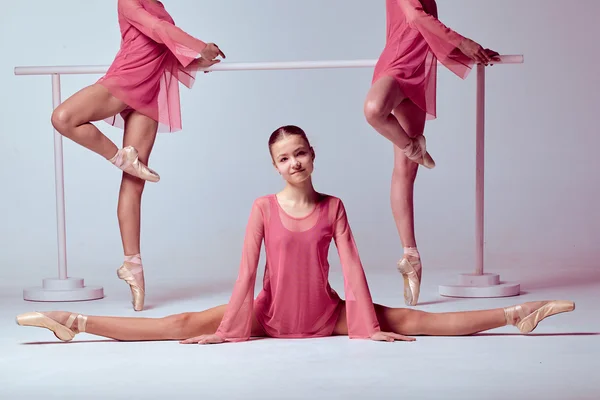 Ballerinas stretching on the bar — Stock Photo, Image