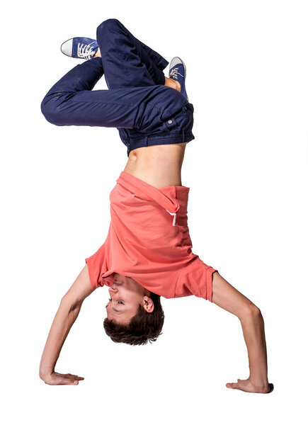 Break dancer doing handstand against  white background