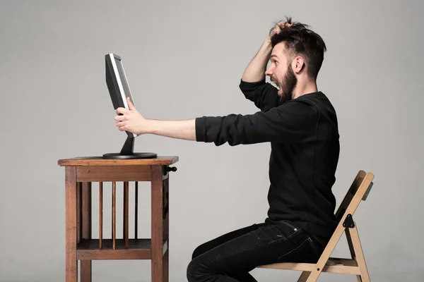 Funny and crazy man using a computer — Stock Photo, Image