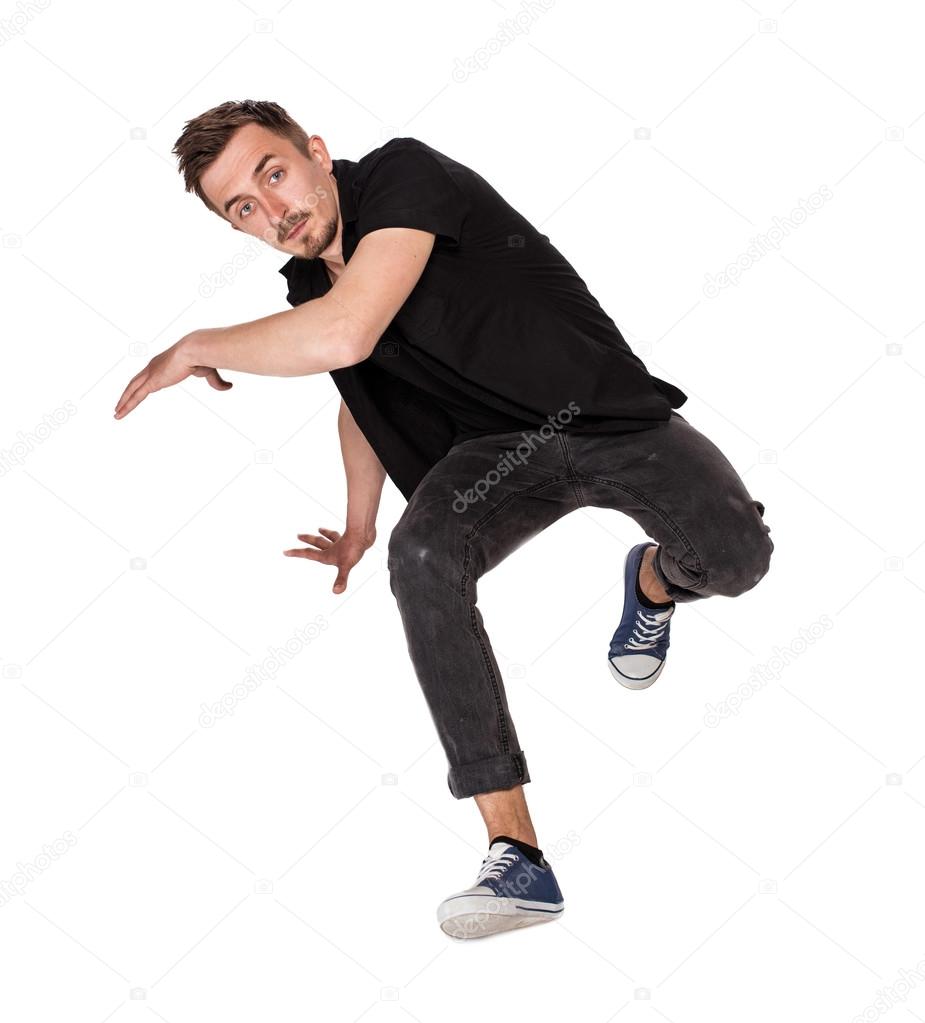 Break dancer doing one handed handstand against a white background