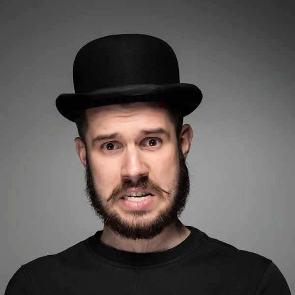 Portrait of young indignant man in studio — Stock Photo, Image