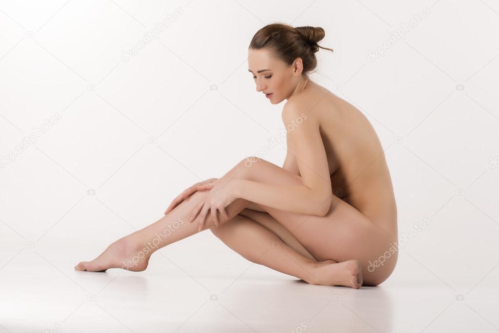 Beautiful caucasian naked woman sitting with fresh clean skin
