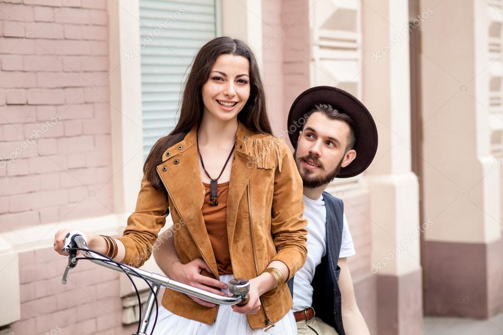 Young couple standing against the wall and hugging