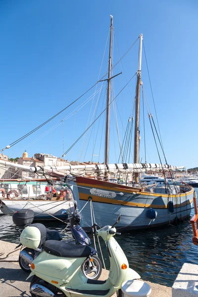 SAINT TROPEZ, FRANCE -  SEPTEMBER 16, 2008: View of Saint Tropez harbor with yachts and bikes . concept of modern modes of transport rich people