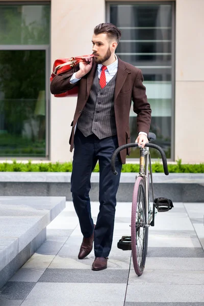 Handsome businessman and his bicycle — Stock Photo, Image