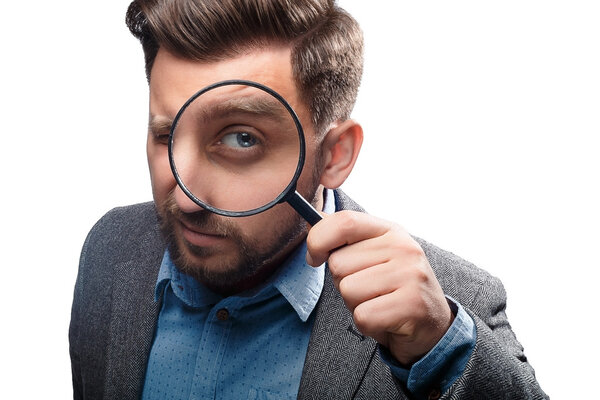 Man with magnifying glass on white background
