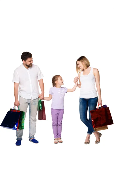 Happy family with shopping bags standing at studio — Stock Photo, Image