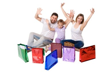 Happy family with shopping bags sitting at studio 