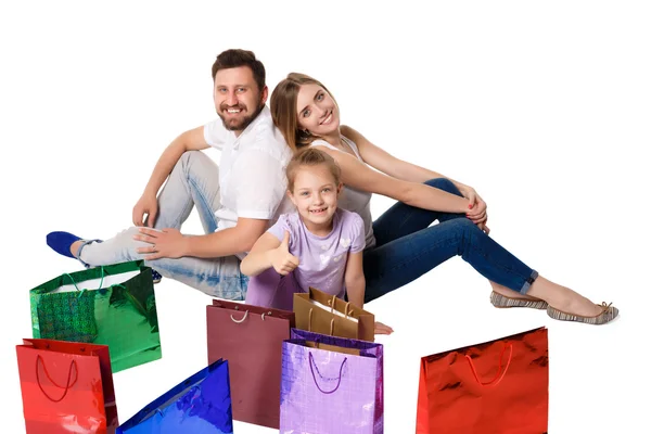 Happy family with shopping bags sitting at studio — 스톡 사진