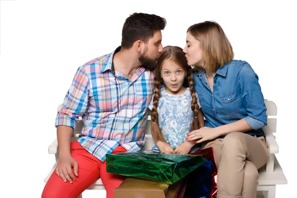 Happy family with shopping bags sitting at studio — Stock Photo, Image