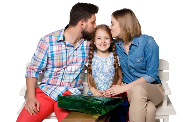 Happy family with shopping bags sitting at studio — Stock fotografie