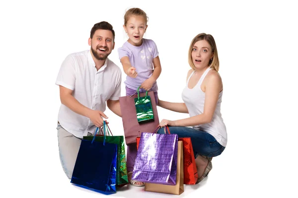 Familia feliz con bolsas de compras sentadas en el estudio — Foto de Stock