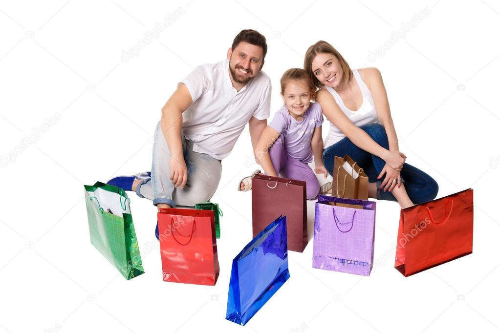 Happy family with shopping bags sitting at studio 