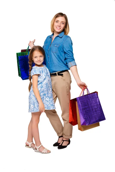 Happy a mother and daughter with shopping bags standing at studio — Stock fotografie