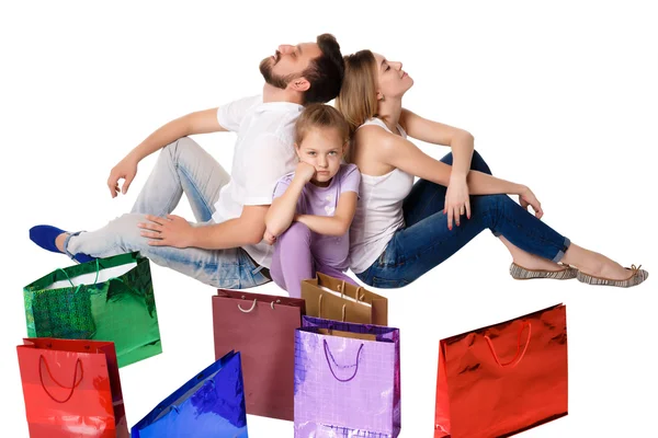 Happy family with shopping bags sitting at studio — Φωτογραφία Αρχείου