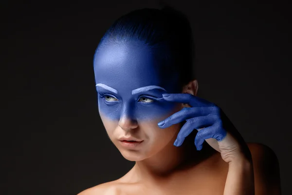 Retrato de uma mulher que está posando coberta de tinta azul — Fotografia de Stock