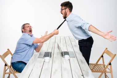 Business conflict. The two men expressing negativity while one man grabbing the necktie of her opponent clipart