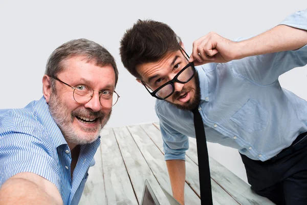 Two colleagues  taking the picture to them self sitting in  office Royalty Free Stock Images