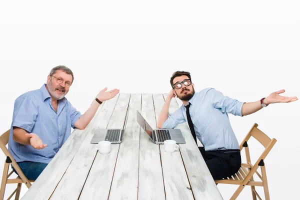 The two colleagues working together at office on white background