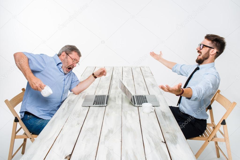 The two colleagues working together at office on white background