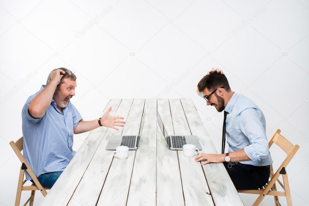 The two colleagues working together at office on white background