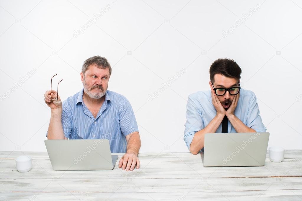 The two colleagues working together at office on white background