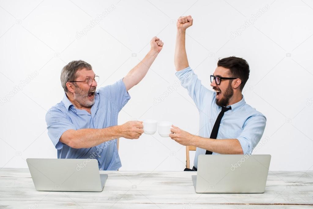 The two colleagues working together at office on white background