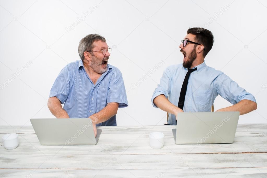 The two colleagues working together at office on white background